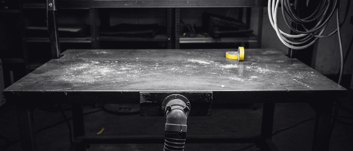 Sanding and prep bench with dust extraction under raking light