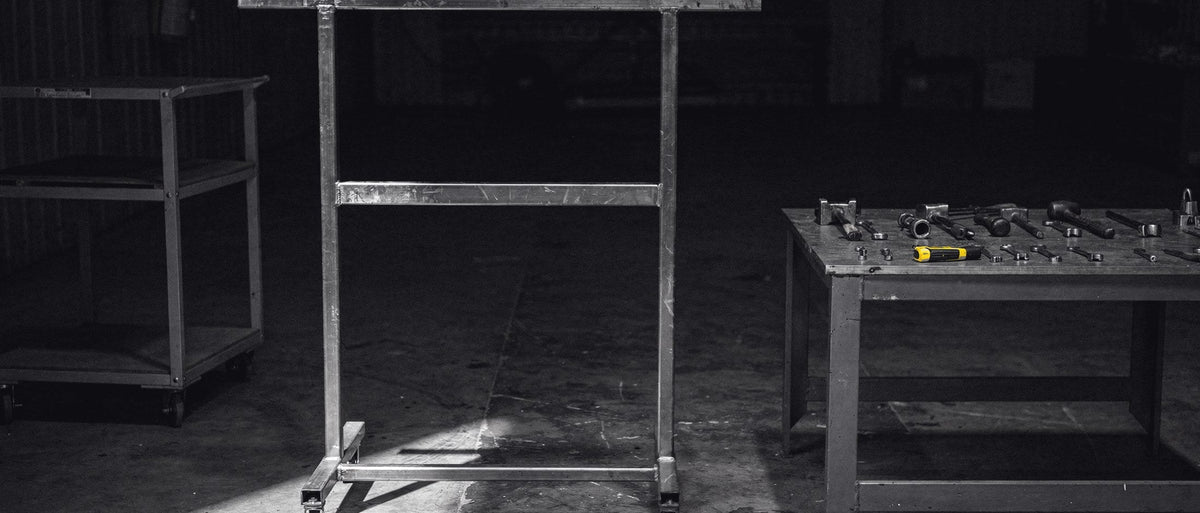 Panel repair bay with an empty stand and a tool bench